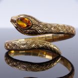 A rolled gold and citrine snake spring bangle bracelet, internal diameter 54mm, head width 15.5mm,