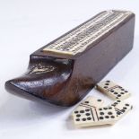 A 19th century carved wood shoe design games box, with bone cribbage board sliding lid enclosing a