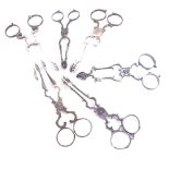 6 pairs of silver scissor action sugar nips, some with engraved initials, 5.4oz total (6 pairs)