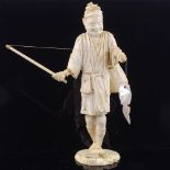 A Japanese ivory okimono depicting a fisherman with a mother-of-pearl fish, Meiji Period, height