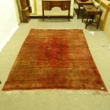 A Persian handmade red ground geometric design rug, 290cm x 208cm.