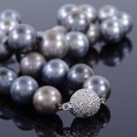 A modern single-strand Princess length black pearl necklace, with 14ct white gold diamond set clasp,