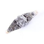 An early 20th century 18ct gold 0.4ct solitaire diamond ring with diamond set shoulders, setting