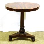 A 19th century exotic wood circular centre table, on tulip carved column and shaped platform base,