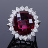 A large 18ct white gold faceted pink rhodolite garnet and diamond cluster ring, total diamond