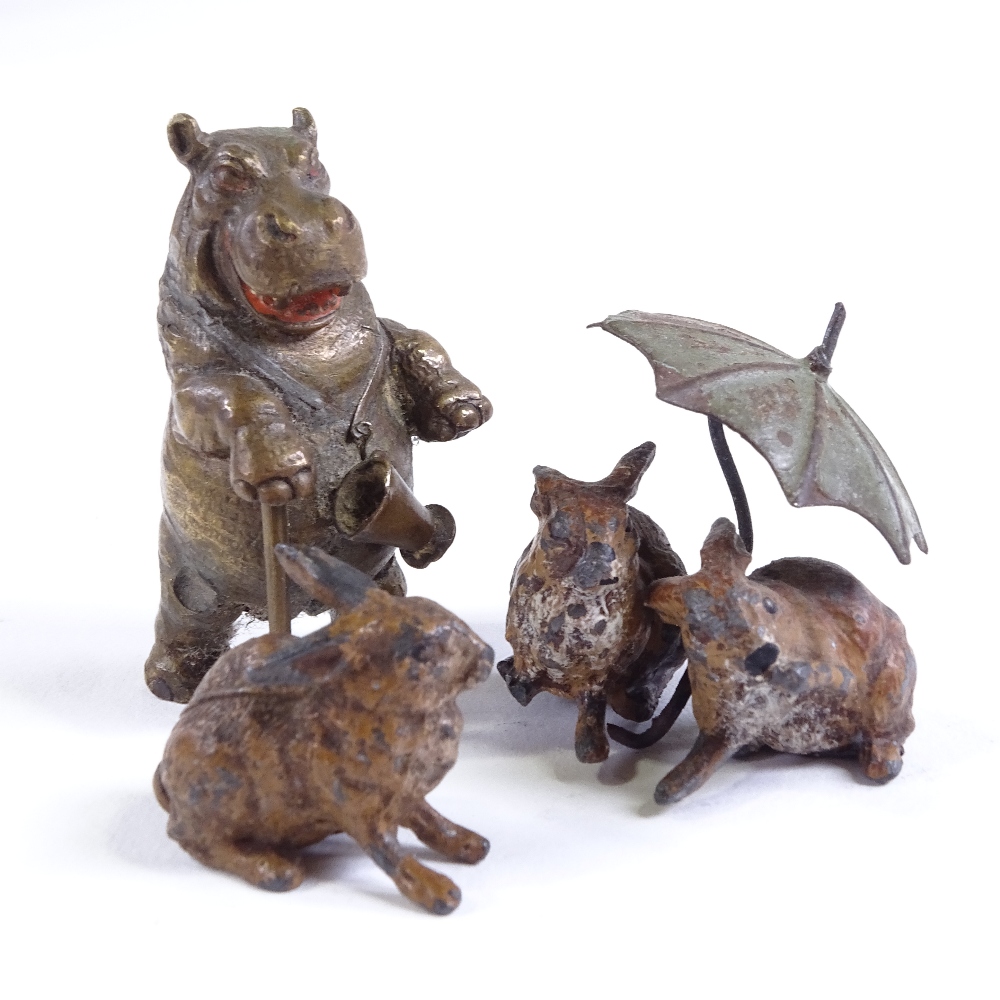 A miniature cold painted bronze caricature hippo with a walking stick, unsigned, height 5cm, and a