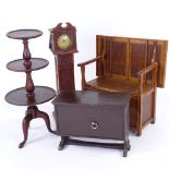 A group of doll's furniture, including oak monk's settle, width 27cm, a miniature longcase clock,