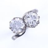 An early 20th century platinum 2-stone CZ crossover ring, stone measurement: diameter - 7.6mm, depth
