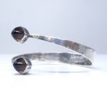 A Gert Thysell for Gussi Swedish silver and smoky quartz modernist torque bangle, each terminal