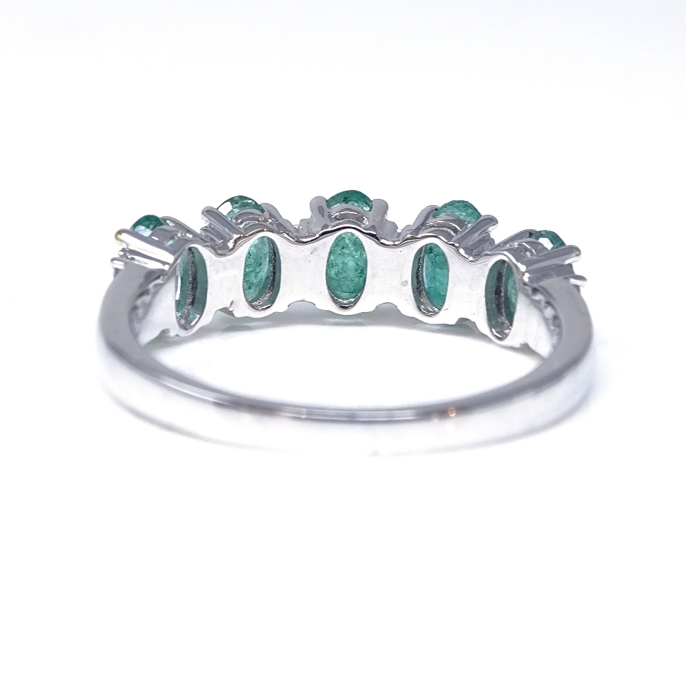 A 14ct white gold emerald and diamond half-hoop ring, total oval-cut emerald content approx 1. - Image 3 of 5