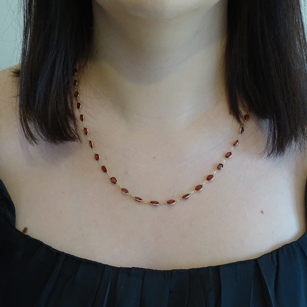 An unmarked gold oval-cut rose garnet line necklace, necklace length 52cm, 7.7g Very good original - Image 7 of 7