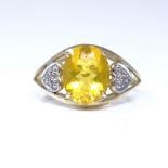 A 9ct gold lemon quartz dress ring, with heart-shaped diamond set shoulders, setting height 11.