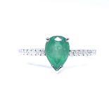A 14ct white gold solitaire emerald ring, with diamond set shoulders, pear-cut emerald approx 1.