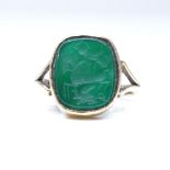A 9ct gold intaglio carved green agate panel seal ring, depicting George and the Dragon, setting
