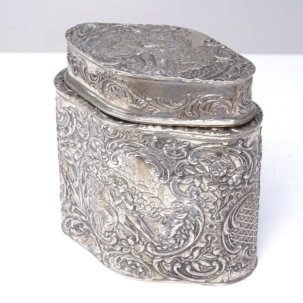 A Continental silver tea caddy, shaped oval form with relief embossed lover scenes within a - Image 2 of 4