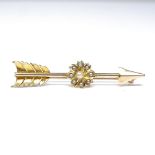 A Victorian 15ct gold pearl arrow brooch, floral centre set with whole and split pearls, brooch