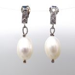 A pair of unmarked gold pearl and diamond drop earrings, total diamond content approx 0.18ct, stud