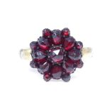 A silver gilt faceted garnet cluster ring, Cubic Zirconia set shank, setting height 15g, size approx