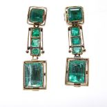 A pair of unmarked gold emerald line drop earrings, total emerald content approx 3.15ct, stud