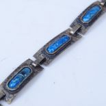 An Arts & Crafts unmarked white metal and blue enamel panel bracelet, bracelet length 19cm, 16.6g