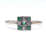 An Art Deco style unmarked gold emerald and diamond chequerboard panel ring, set with square step