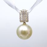 A 14ct gold South Sea cultured pearl and diamond cluster pendant, pearl diameter 12.6mm, pendant