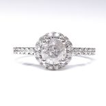 A 14ct white gold diamond halo cluster ring, with diamond set shoulders and pierced bridge,