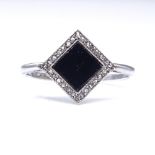 An Art Deco onyx and rose-cut diamond panel ring, platinum shank and 18ct gold settings, panel