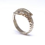 A 9ct gold snake / serpent ring, set with garnet eyes and all over engraved scales, maker's marks