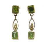 A pair of 14ct gold peridot drop earrings, set with emerald cut peridots and pierced settings,