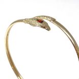 A 9ct gold cobra snake / serpent torque bangle, set with a pear-cut garnet head and round-cut garnet
