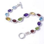 A sterling silver vari-cut gem-set bracelet, gems include amethyst, citrine, peridot, blue topaz and