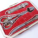 A 19th century unmarked silver manicure set, comprising needle case, scissors, thimble and knife,