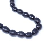 A graduated polished jet bead necklace, largest bead length 14mm, necklace length 50cm, 36.8g Good