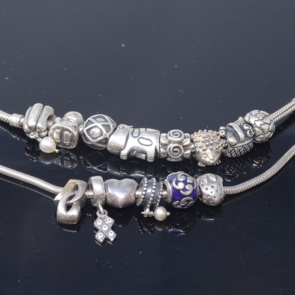 14 Pandora silver charms, on 2 unnamed sterling silver snake-link necklaces, necklace lengths 50cm