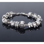 17 Pandora silver charms and spacer links, on an unnamed sterling silver charm bracelet, bracelet
