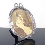 An Art Nouveau Danish oval silver-fronted photo frame, bow decoration with stand, hanging loop and