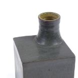 A Studio Pottery greyish green glaze square-section vase, offset neck, incised maker's mark JW to