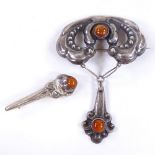 A large Art Nouveau Danish unmarked white metal and amber drop brooch, and a similar Danish silver