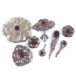 8 Art Nouveau Scandinavian stylised silver white metal and red stone floral brooches and a