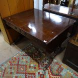 A Regency ebony-strung mahogany sofa table, with opposing drawers, raised on quadruple turned