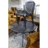 A black metal circular garden table, and 4 matching stacking chairs