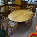 An Ercol "Southwold" honey elm oval dining table, L165cm, together with a set of 4 Ercol "Penn"