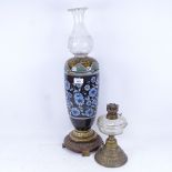 A Doulton Lambeth stoneware oil lamp, and a smaller brass oil lamp, largest height excluding shade