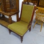 An Edwardian carved walnut-framed and upholstered nursing chair