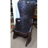 An unusual solid tree trunk dugout chair or Kubbestol, with adzed finish and sculpted seat