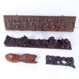 A 19th century carved and stained oak floral wall ornament, another, and a carved fruitwood lion,
