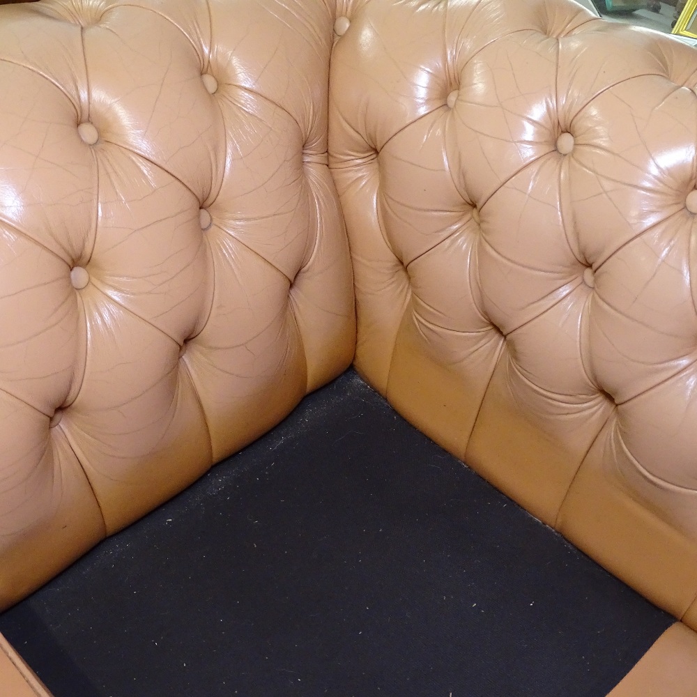 A salmon coloured button-backed leather upholstered 2-seater rollover arm settee, L150cm, H67cm, - Image 2 of 2