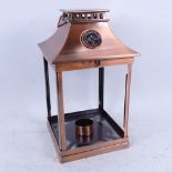 A Thomas Kinkade copper-framed lantern, with glass panels depicting cottages, height 31cm