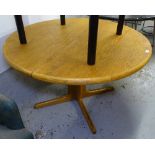 A mid-century Danish teak circular extending dining table, with 2 spare leaves, raised on a flat 4-